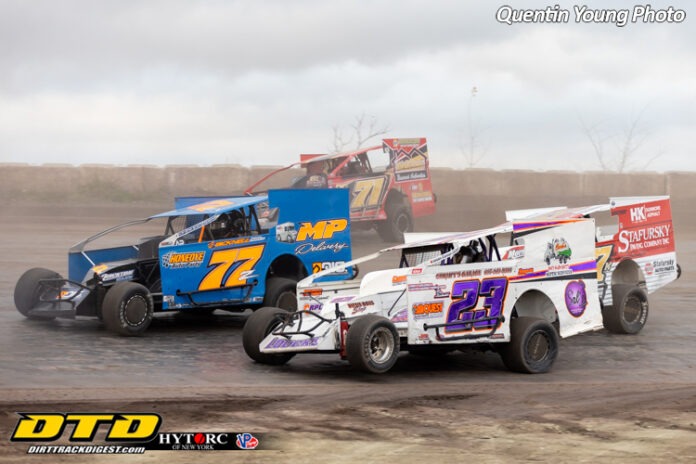 Dirt track racers competing at speed