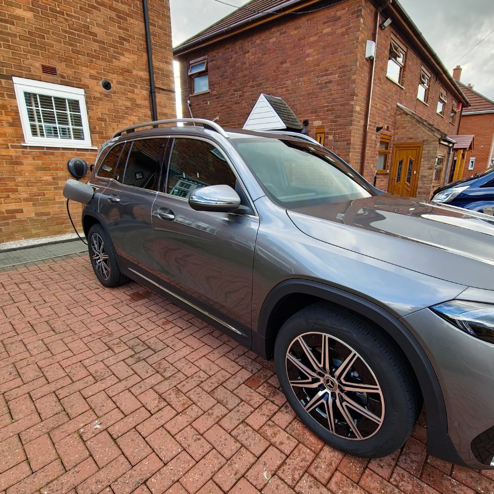 Gray SUV charging with Pod Point