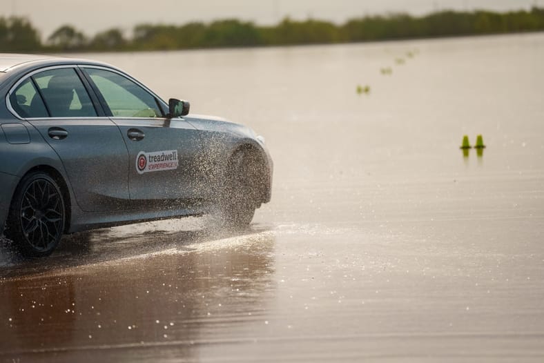 Car driving on wet VDA track