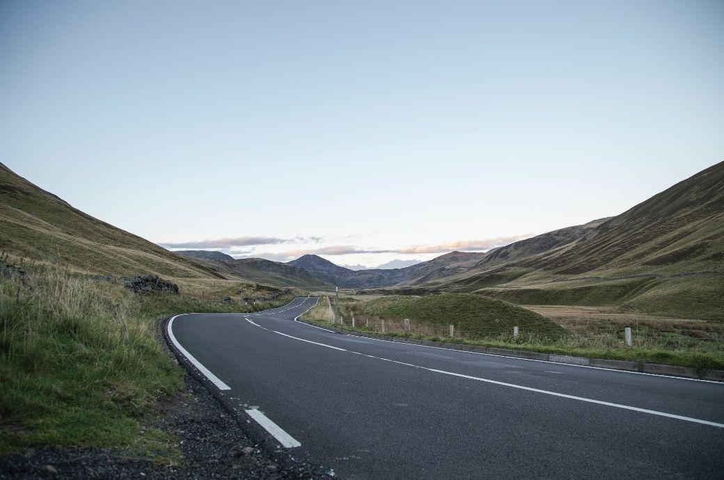 Rural road through green hills