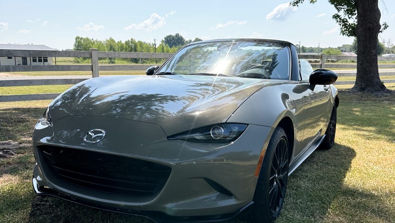 Red Mazda Miata on mountain road