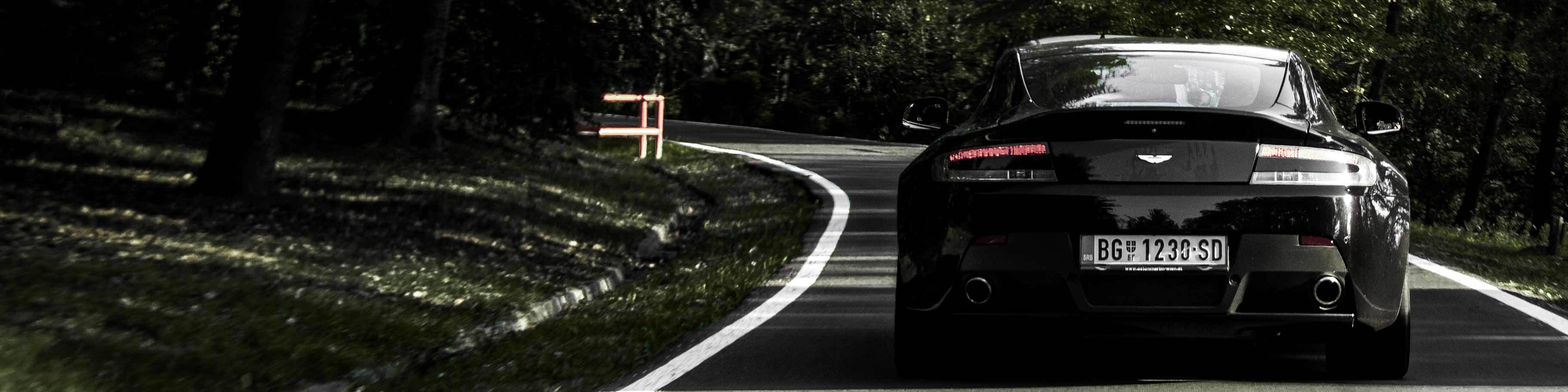 Black Aston Martin on road