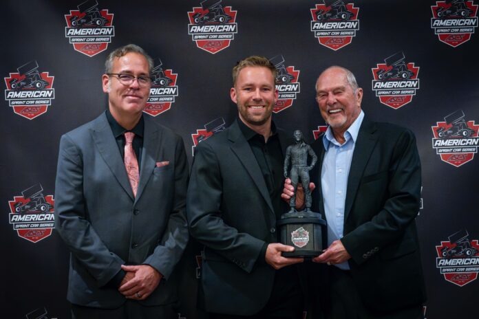 Three men celebrating racing trophy victory