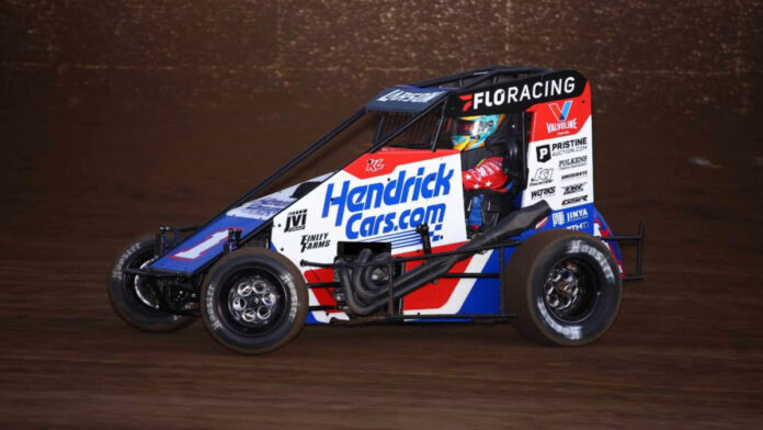 Racing car speeds on dirt oval