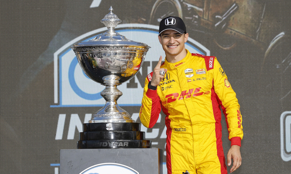 Racing driver holding trophy