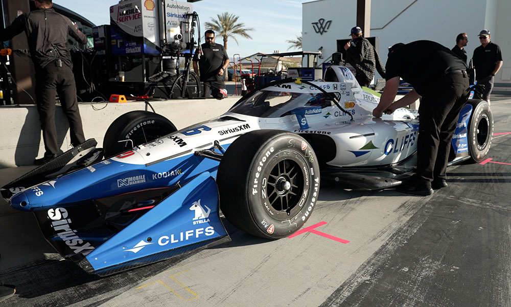 Racing crew working on white car