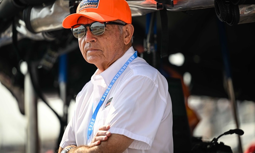 Man in orange IndyCar team hat