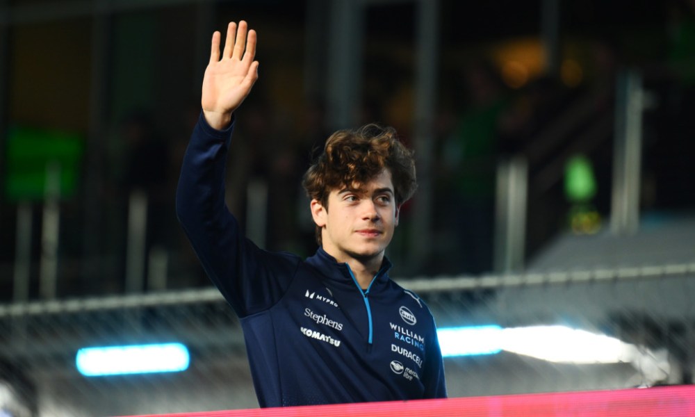 Race driver waving to camera