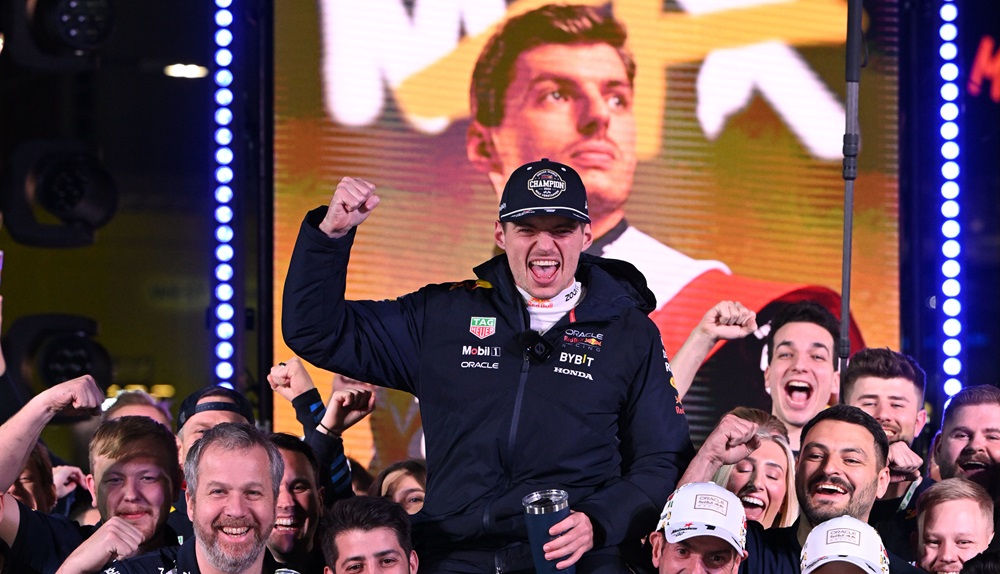 Smiling racer celebrates in racing suit