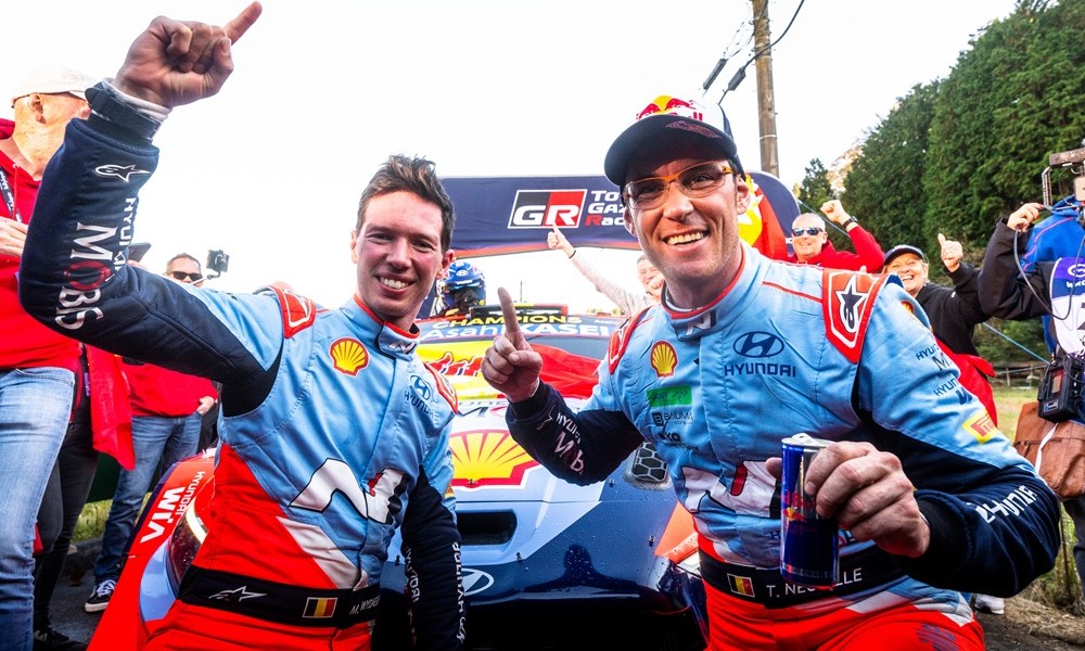 Racing drivers celebrating victory trackside