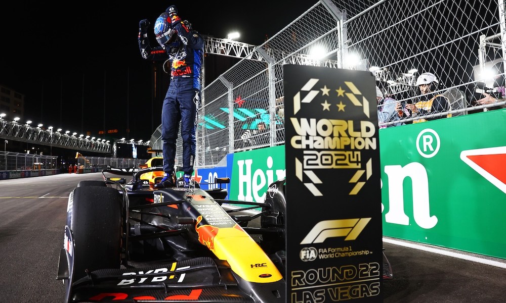 Race driver celebrates atop winning car