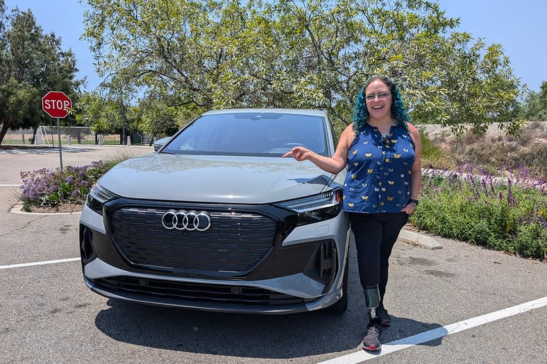 Woman beside Audi Q4 e-tron SUV