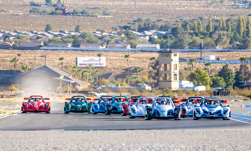 Race cars compete in desert landscape