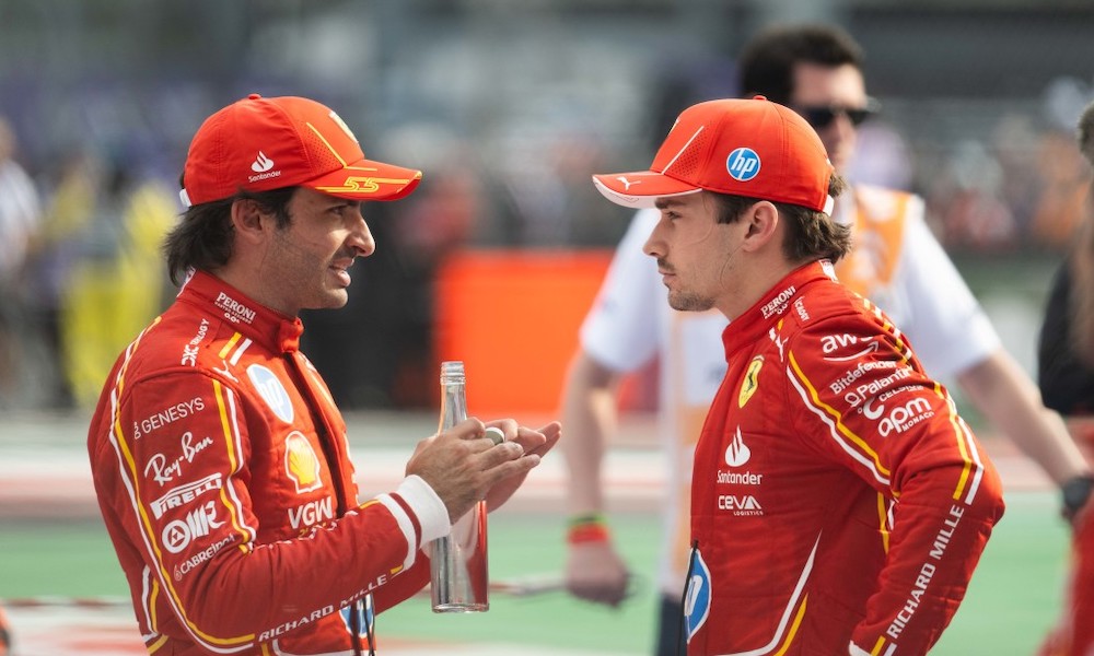 Two drivers discuss at racing circuit