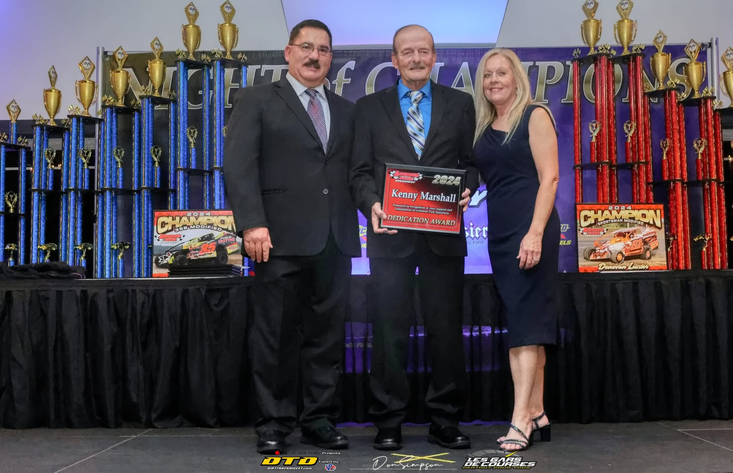 Man proudly displays racing trophy