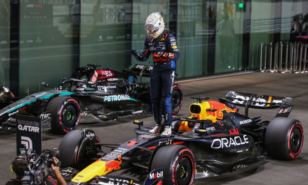 Driver stands atop racing car