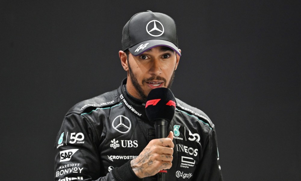 Lewis Hamilton speaks into mic