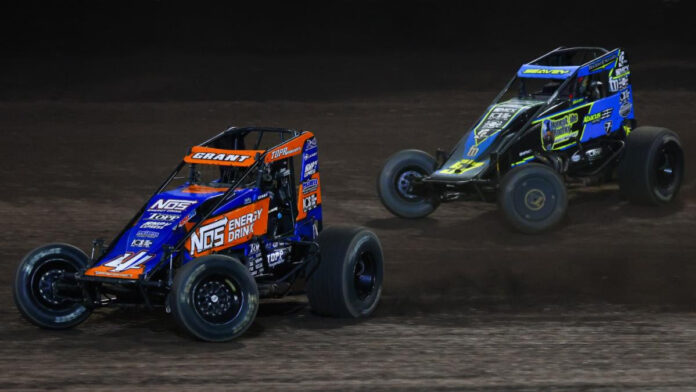 Two dirt track racers competing