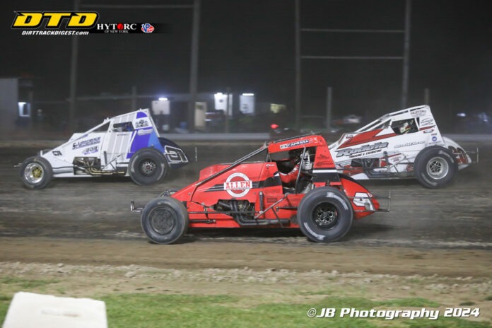 Sprint cars racing on dirt track