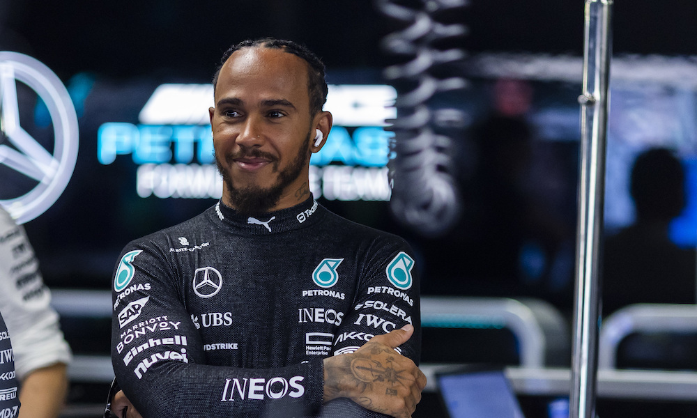 Lewis Hamilton in racing suit smiling