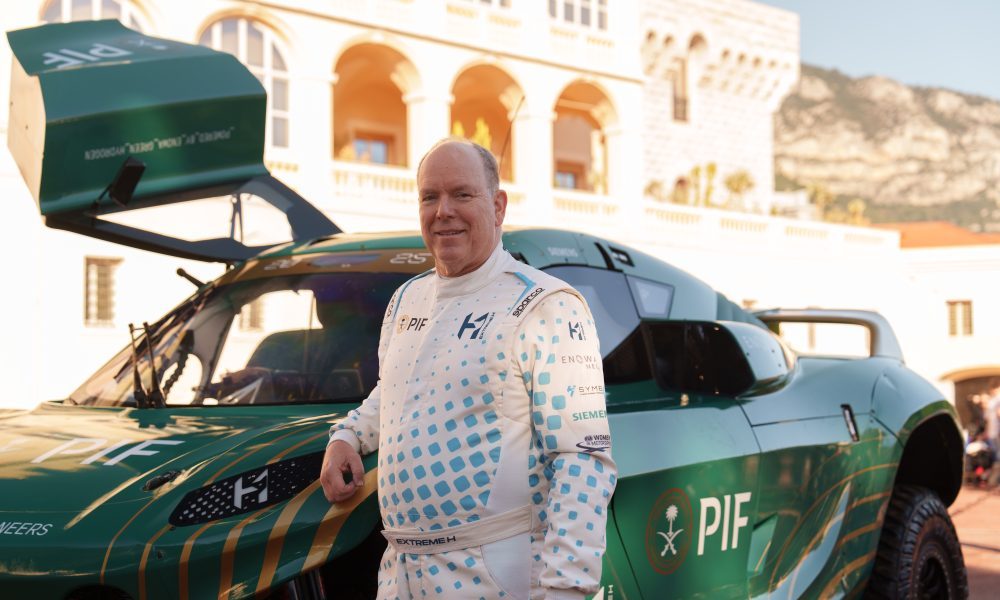 Man poses with hydrogen race car