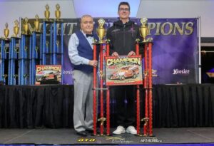 Man holding racing trophy