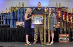 Man celebrates with dirt track trophy