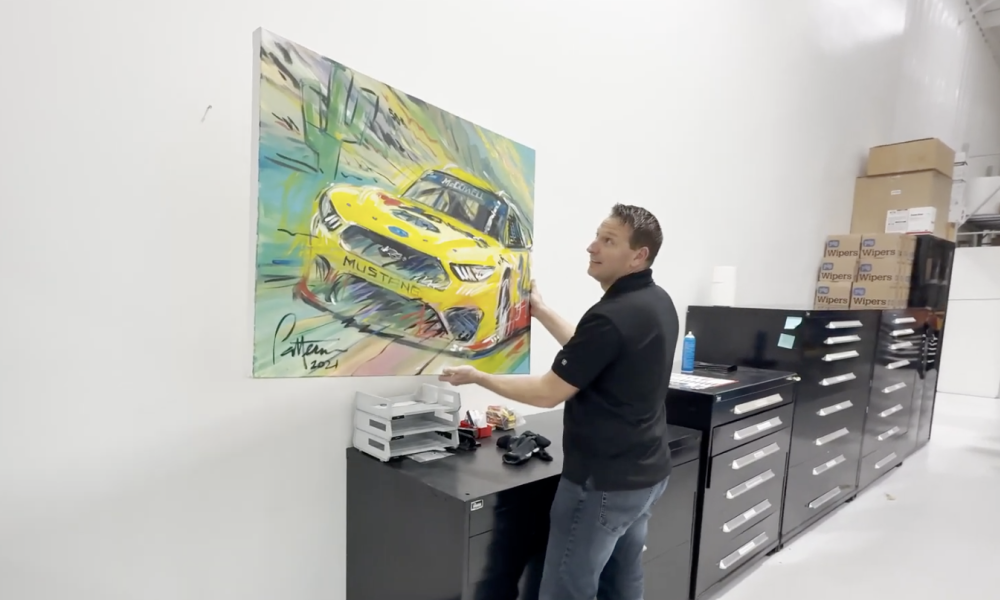 Yellow Pennzoil IndyCar on wall art