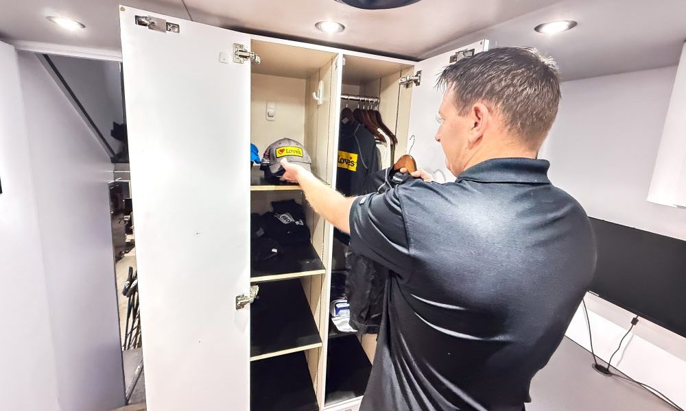 NASCAR driver opening white cabinet