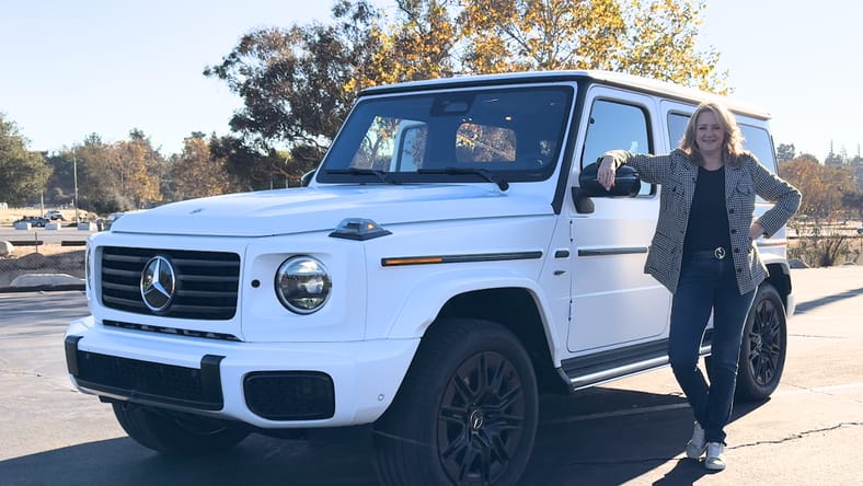 Woman next to Mercedes G-Wagen