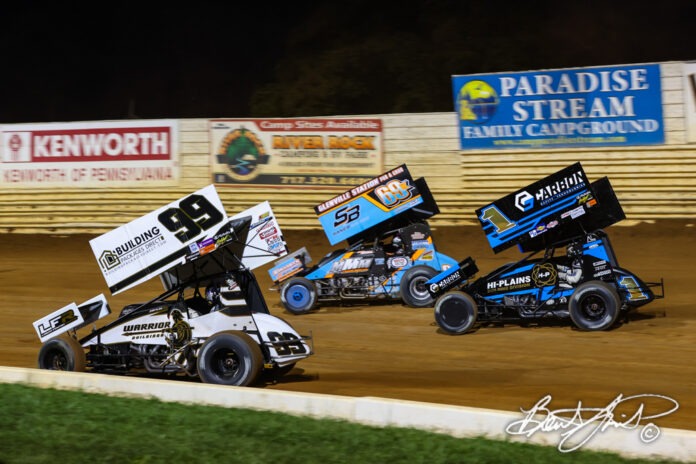 Sprint cars racing at night