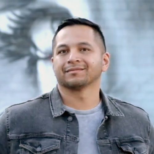 Smiling man in denim jacket