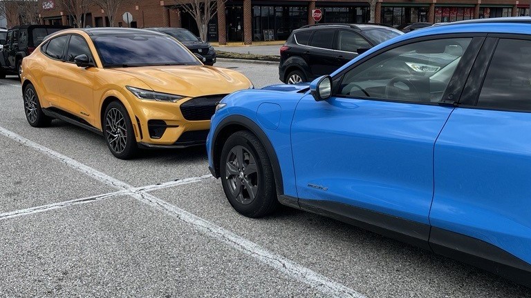 Two EVs parked at charging station