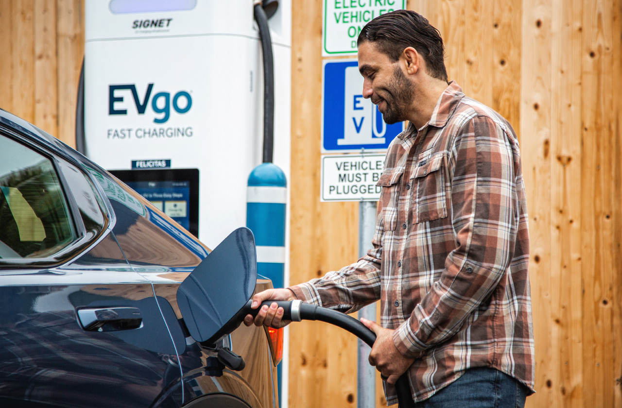 Man plugging in EVgo charger