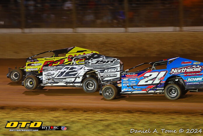 Three dirt track racers in action