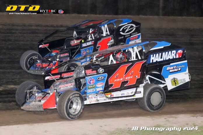 Two stock cars racing on dirt