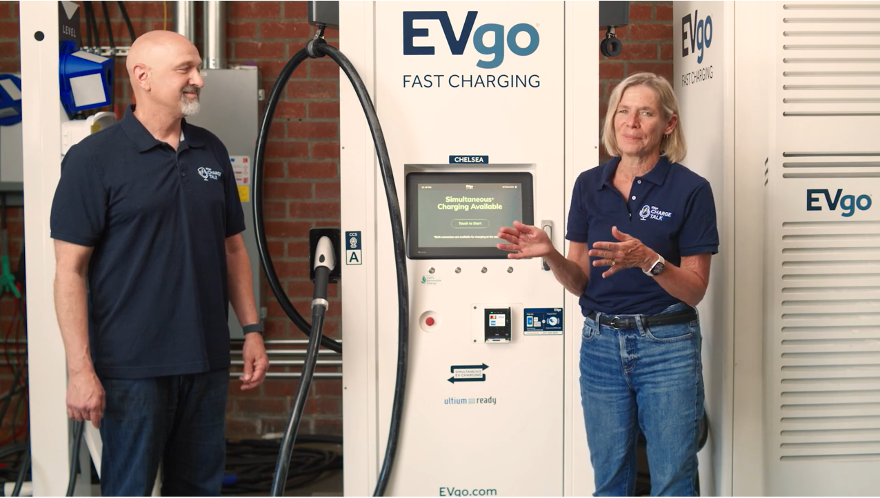 Man and woman discuss charging station