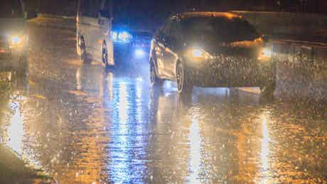 Cars driving through storm conditions