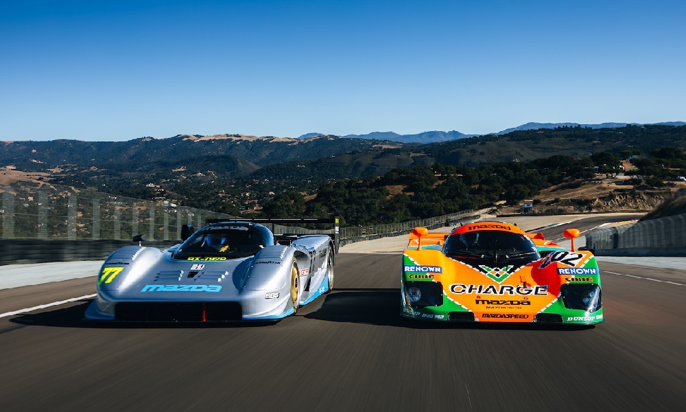 Two racecars speeding side-by-side