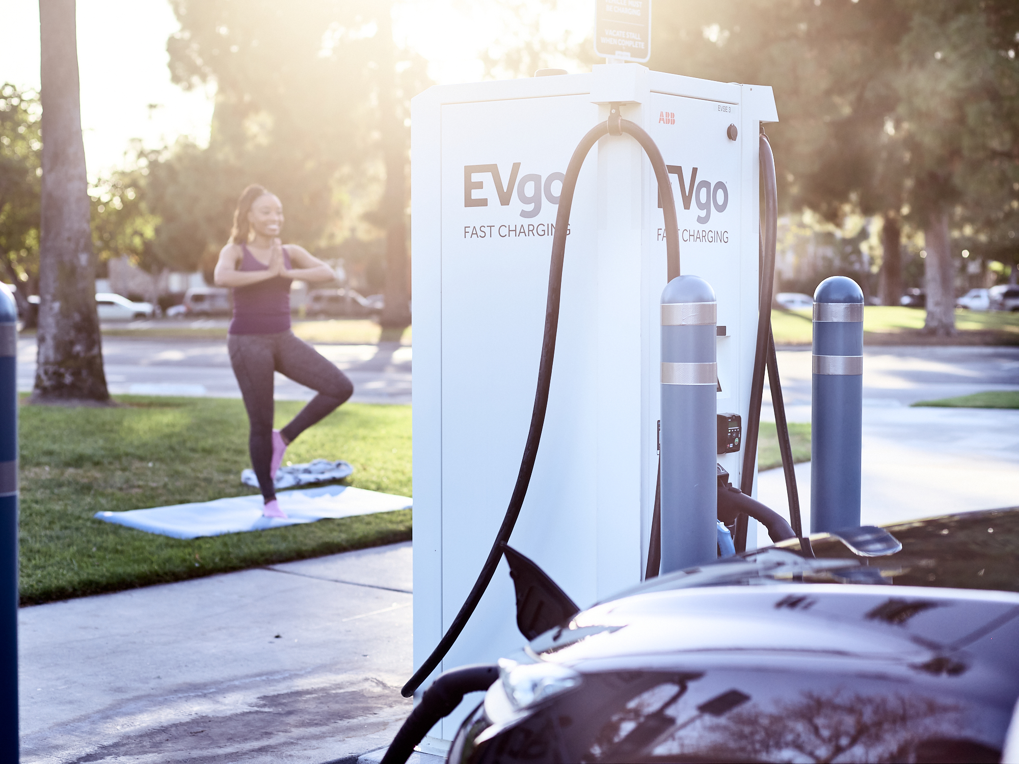 Woman in yoga pose at charger