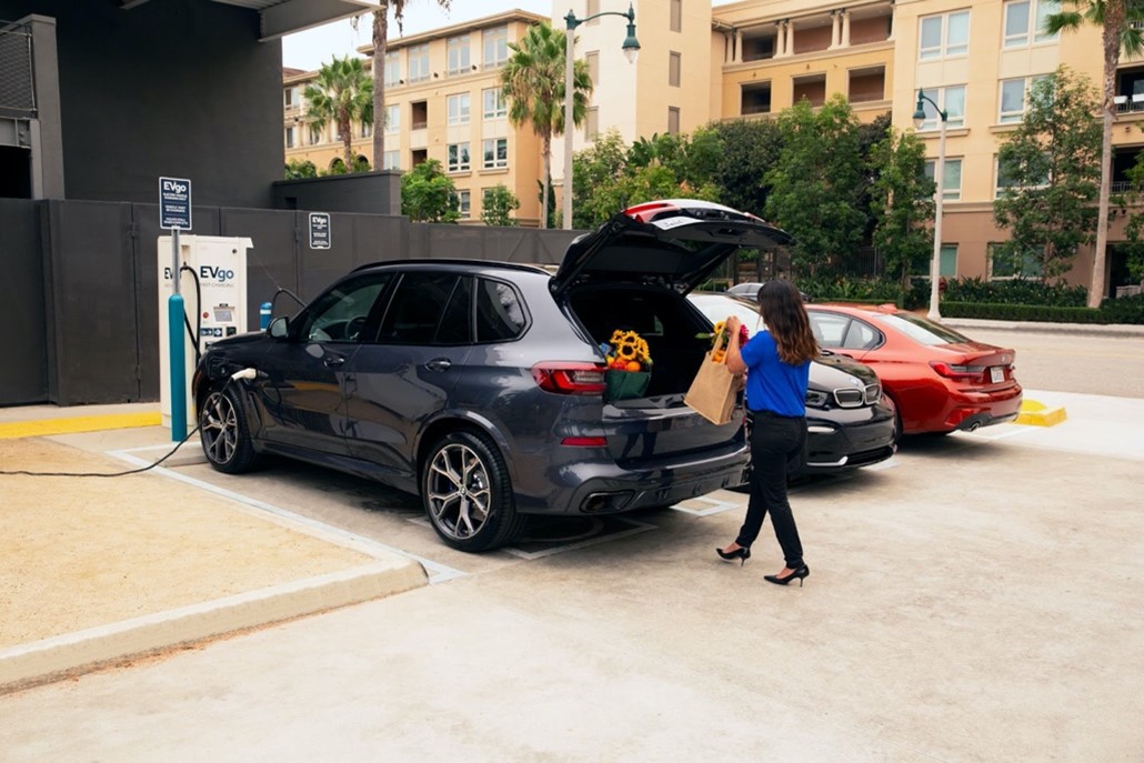 Woman charging BMW at EV station