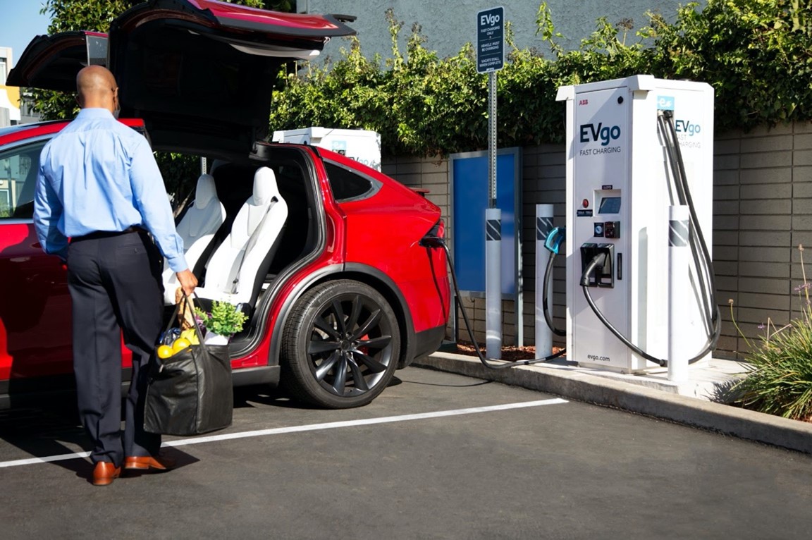 Man unloads Tesla near charging station