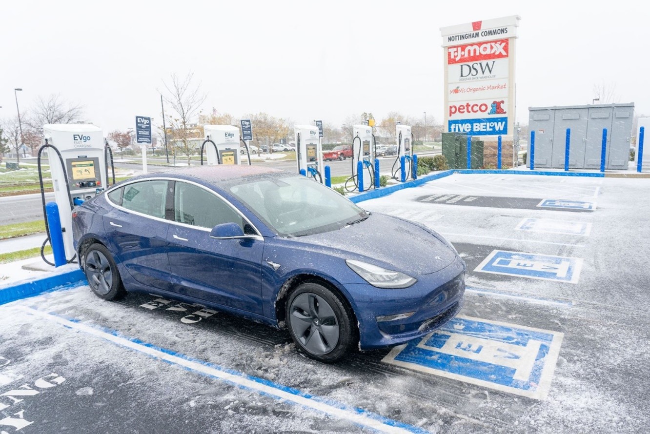 Tesla parked in snowy parking lot