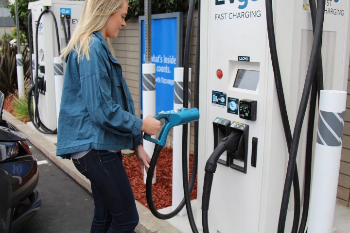 Woman charging at EVgo station