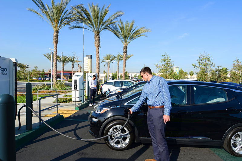 Man charging EV at EVgo station