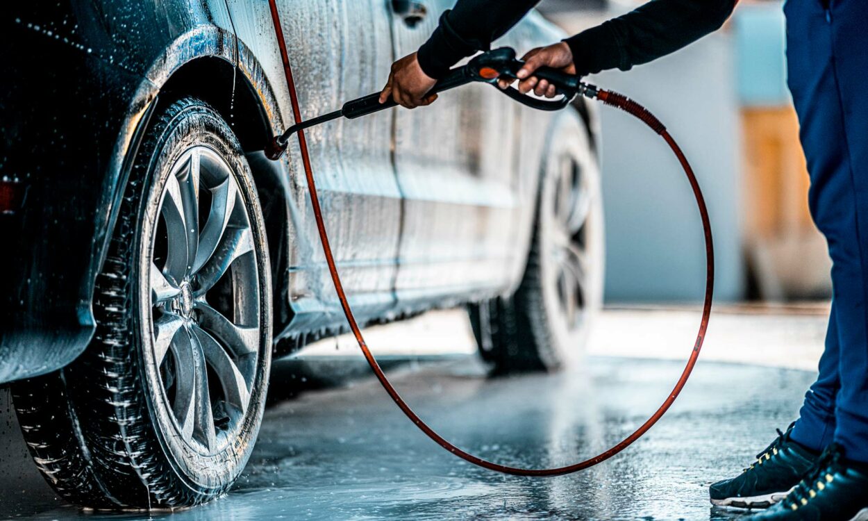 Man cleaning car wheel with soap