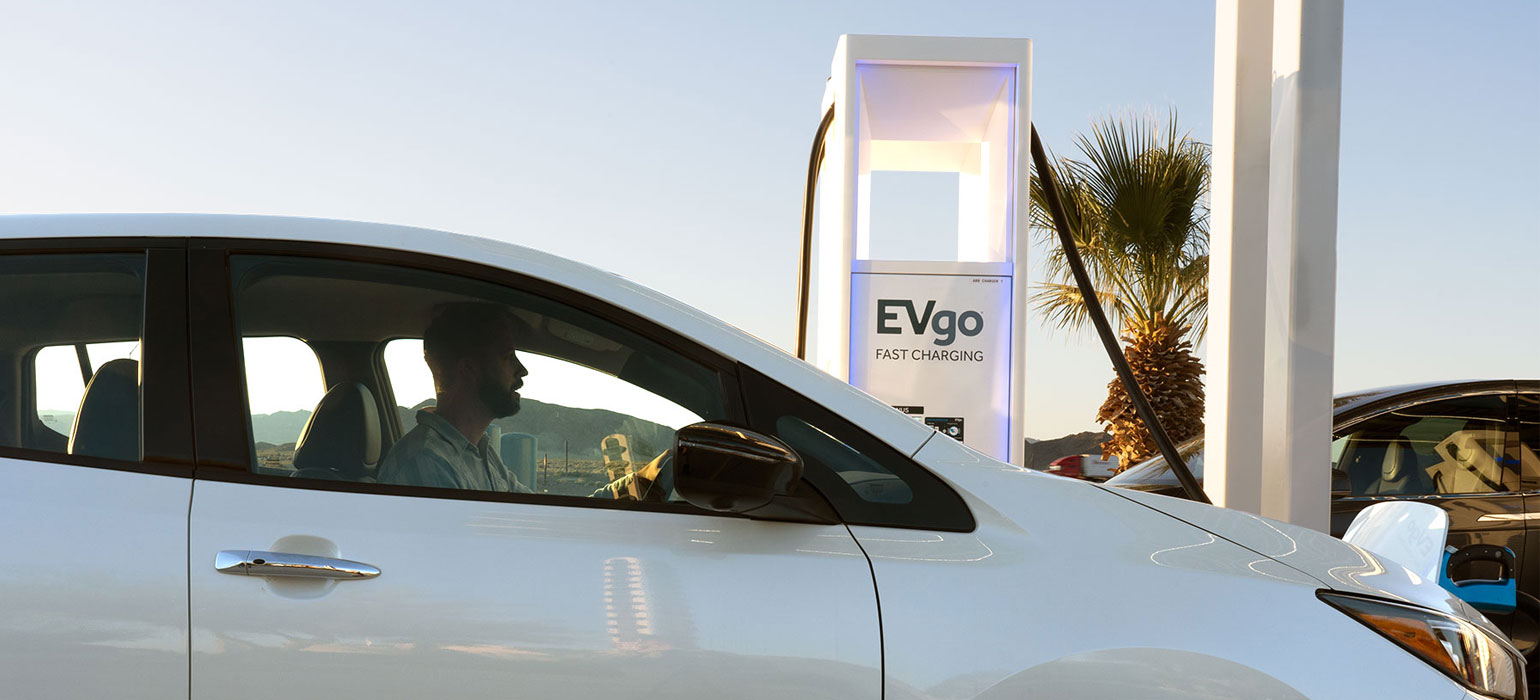 Man charging Nissan at EVgo station