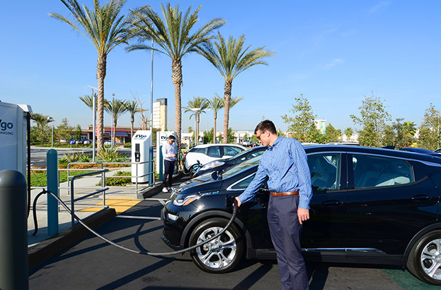 Man charging Chevy Volt