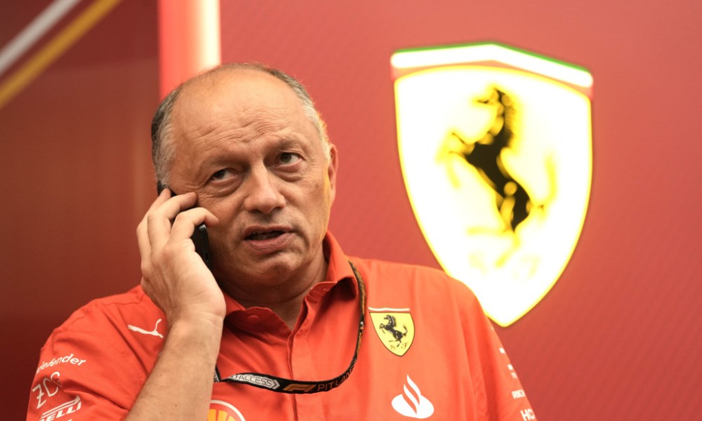 Man at Ferrari F1 holding phone