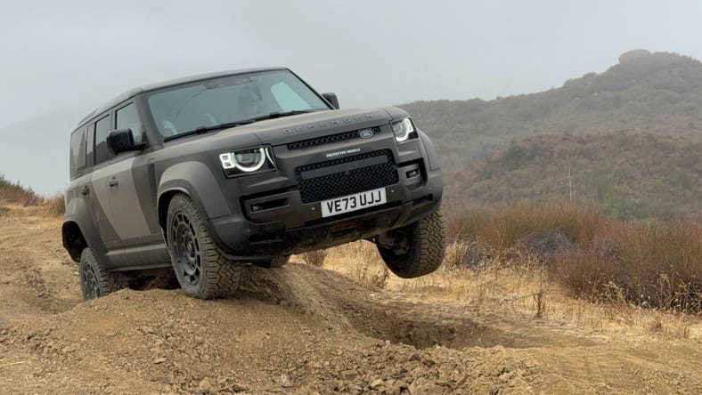 Land Rover navigating rough mountain terrain